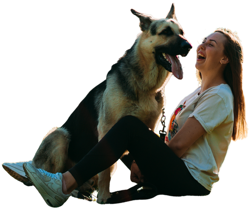 A dog walker in Sacramento sitting and laughing with a dog on a leash